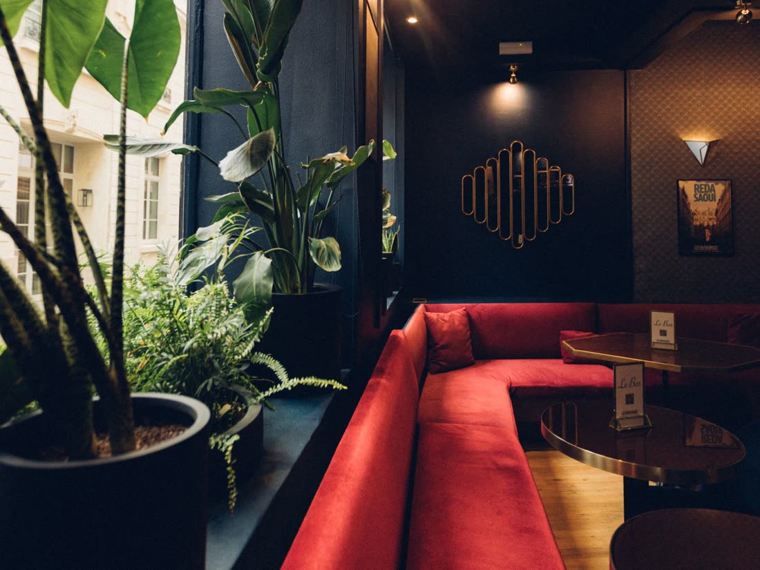 The foyer lounge, red banquette and art deco wall light